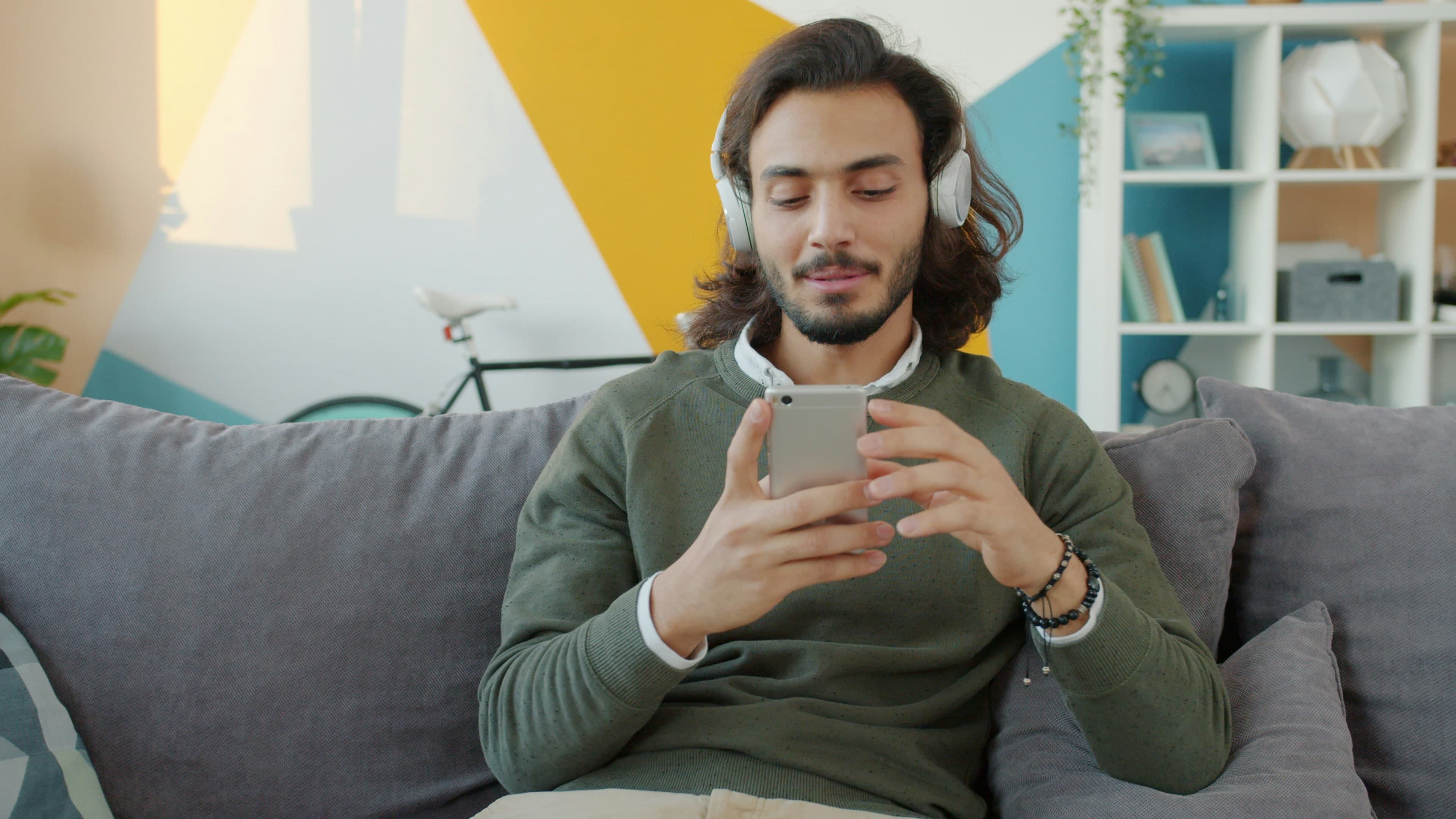A man browsing dental services on his phone at home